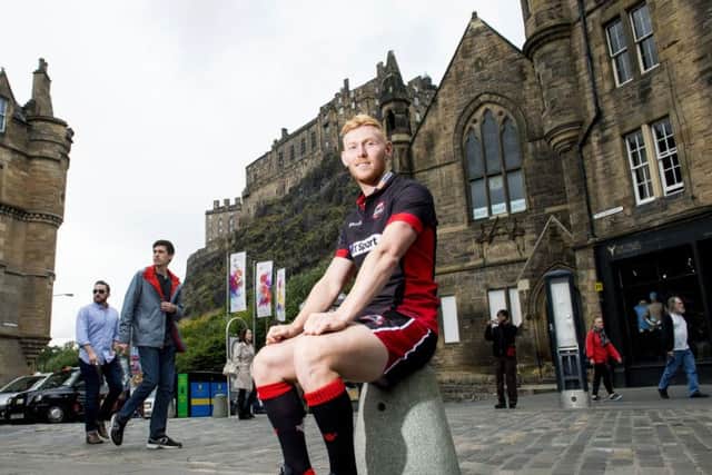 Rory Scholes, who has joined Edinburgh Rugby from Ulster, helps launch the capital clubs new kit in the Grassmarket yesterday. Picture: SNS
