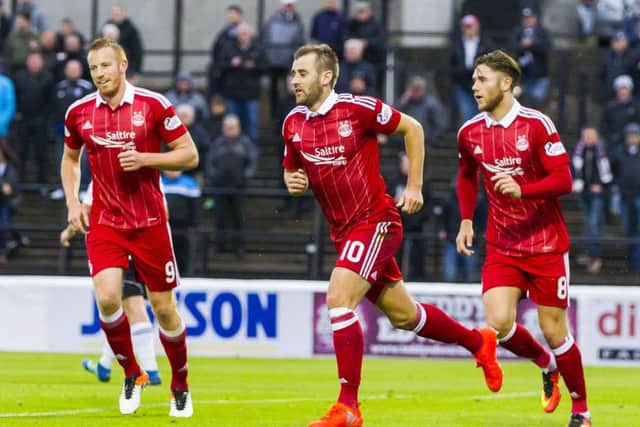 Niall McGinn, centre, celebrates having put Aberdeen 2-0 up. Picture: SNS