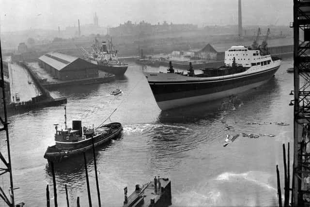 The MV Bamora is towed west along the Clyde shortly after being launched at the Harland & Wolff shipyard in September 1960. The yard was adjacent to the graving docks. Picture: TSPL