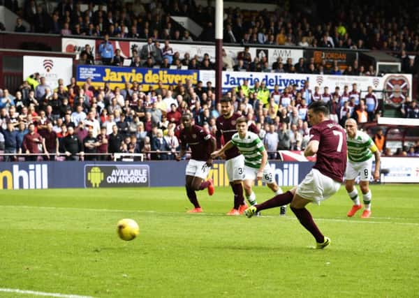 Jamie Walker tucks away the penalty after "diving" to win the spot-kick. Picture: SNS