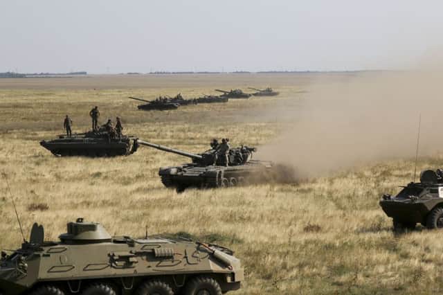 Ukrainian tanks and armoured personnel carriers move towards the de-facto border with Crimea near Kherson yesterday. Picture: AP