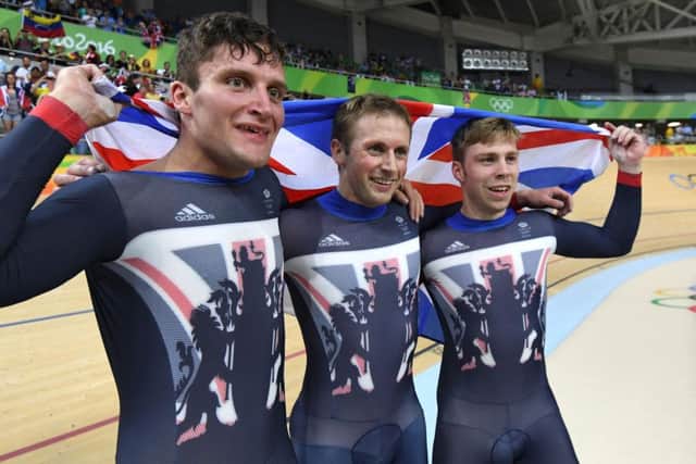 Britain's Callum Skinner, Jason Kenny and Philip Hindes celebrate their gold. Picture: Greg Baker/AFP/Getty Images