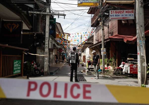 Thai police officers stand at the site of an explosion. Picture: Getty