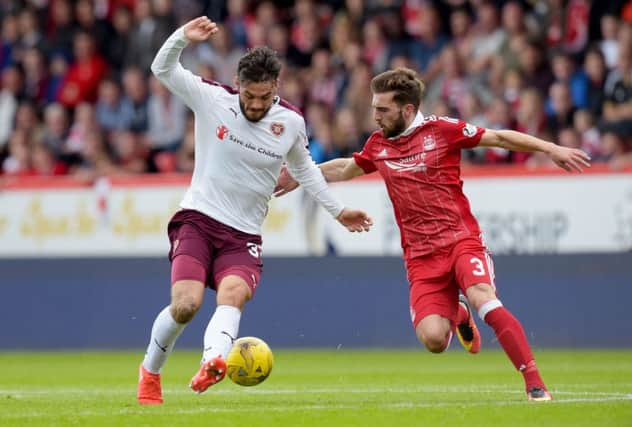 Hearts' Tony Watt (left) battles with Graeme Shinnie in the goalless draw at Pittodrie. Picture: Getty