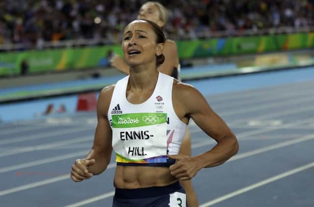 Jessica Ennis-Hill grimaces as she finishes the 800m but was soon smiling after taking silver