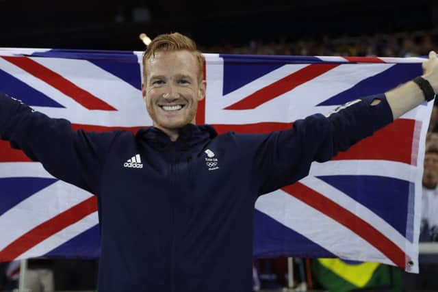 Britain's Greg Rutherford recovers from his initial disappointment to celebrate his bronze medal. PICTURE: AP