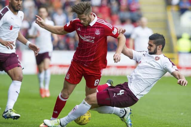 Hearts defender Igor Rossi slides in to tackle Aberdeens Wes Burns during Saturdays 0-0 draw at Pittodrie. Picture: SNS Group