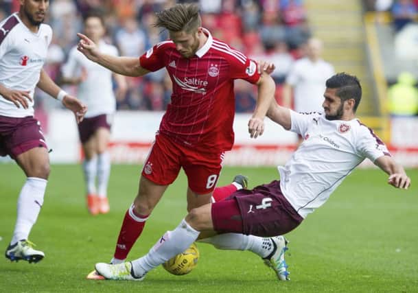 Hearts defender Igor Rossi slides in to tackle Aberdeens Wes Burns during Saturdays 0-0 draw at Pittodrie. Picture: SNS Group
