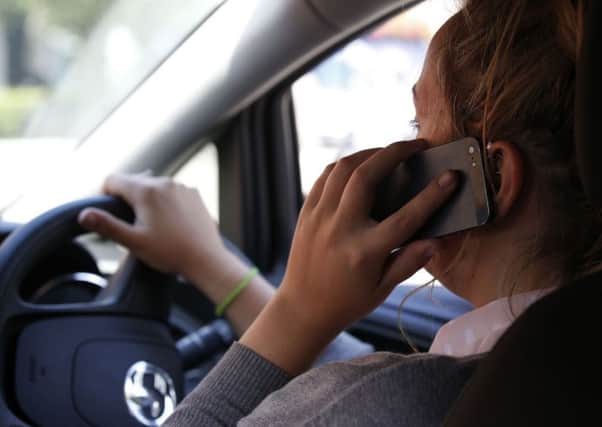 Drivers using mobile phones risk incurring penalty points and a fine  as well as causing crashes. Picture: PA