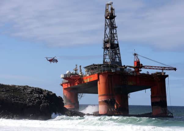A Coastguard helicopter hovers above the stranded Transocean Winner as salvage crews battled difficult weather conditions to get on board the rig. Picture: PA