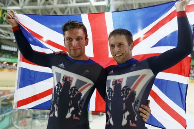 Callum Skinner, left, celebrates his silver with team-mate and conqueror Jason Kenny, who took his tally to five Olympic golds in the all-GB sprint final. PICTURE: Getty Images