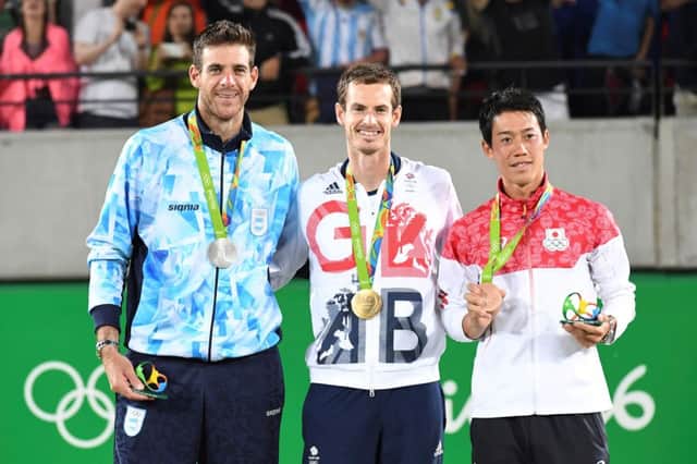 Gold medallist Britain's Andy Murray, centre is flanked by fellow medallists Juan Martin del Potro, left and Kei Nishikori. PICTURE: Getty Images