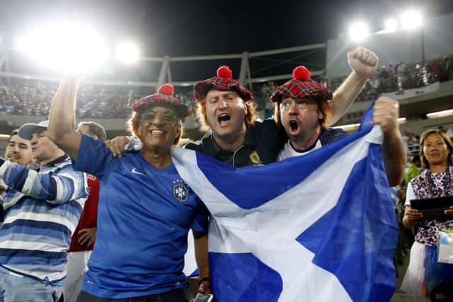 Some Scots in the crowd recruit some Brazilian support for their man