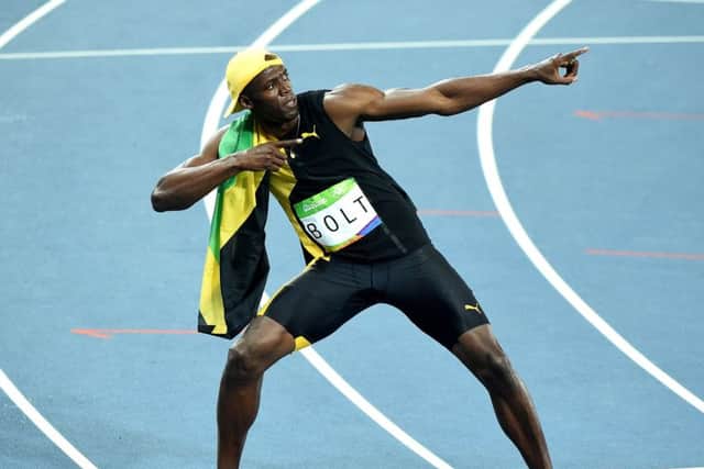 Usain Bolt showboats for the crowd after his victory. Picture: Getty
