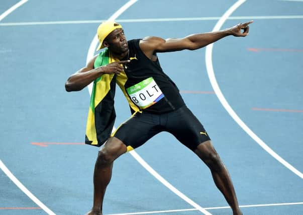 Usain Bolt showboats for the crowd after his victory. Picture: Getty