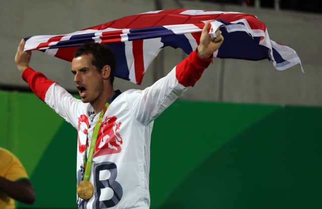Andy Murray is draped in the flag after receiving the gold medal yesterday. Picture: PA