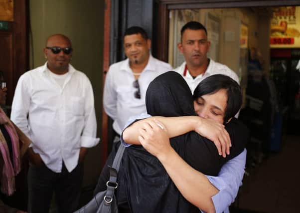 Celeste Nurse, right, the biological mother of the kidnapped child, Zephany Nurse, embraces a family member after the court proceedings. Picture: AP