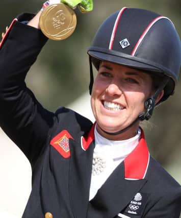 Alamy Live News. GJDTRY Rio de Janeiro, Brazil. 15th Aug, 2016. Gold medalist Charlotte Dujardin (Valegro) of Great Britain celebrates during the medal ceremony of the Dressage Individual Grand Prix Freestyle of the Equestrian events in Deodoro during the Rio 2016 Olympic Games at the Olympic Equestrian Centre in Rio de Janeiro, Brazil, 15 August 2016. Photo: Friso Gentsch/dpa/Alamy Live News This is an Alamy Live News image and may not be part of your current Alamy deal . If you are unsure, please contact our sales team to check.