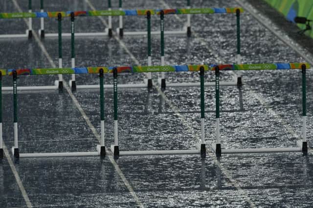 Heavy rain during the men's 110m hurdles heats lead to a half-hour delay in Rio