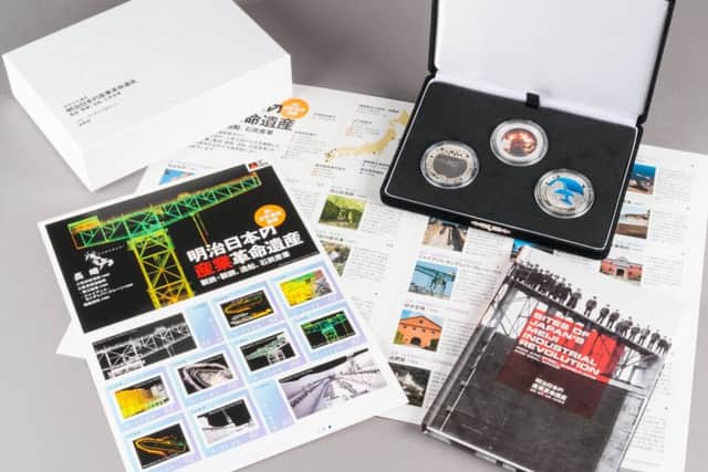 A set of commemorative coins and stamps of an historic industrial site in Japan. Picture: Duncan Peet/Historic Environment Scotland/PA Wire