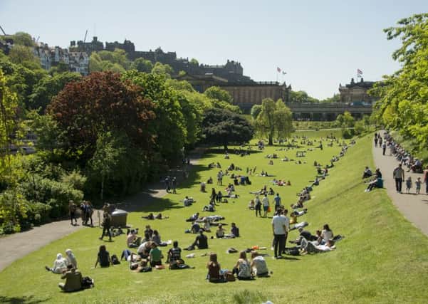 Summer has arrived and tourists and locals take to Princes Street Gardens for a spot of sunbathing