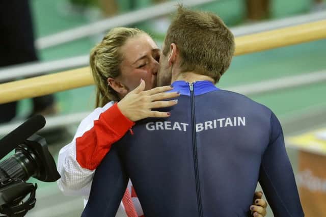 Laura Trott, left, kisses her fiance Jason Kenny. The pair contributed five gold medals between them. Picture:  Victor R. Caivano/AP