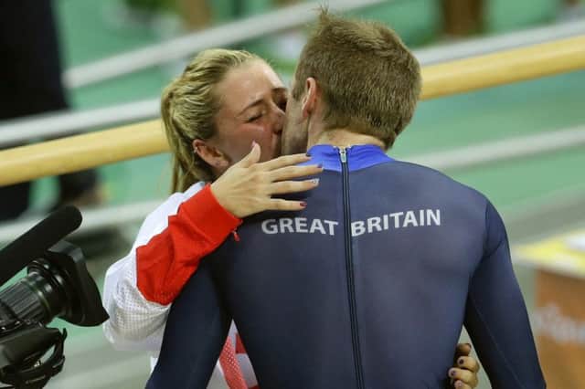 Laura Trott, left, kisses her fiance Jason Kenny. The pair contributed five gold medals between them. Picture: Victor R. Caivano/AP