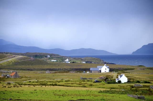 Cottages on the Applecross peninsula with stormy skies in the background.