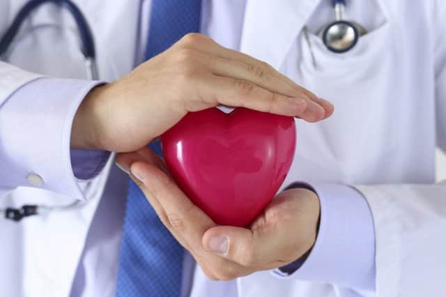 Male medicine doctor holding red toy heart. Picture: Contributed
