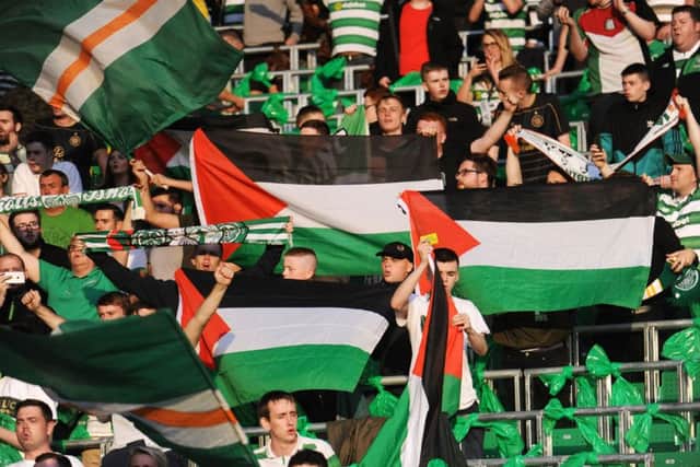 Celtic fans with Palestine flags at last night's game. Picture: John Devlin