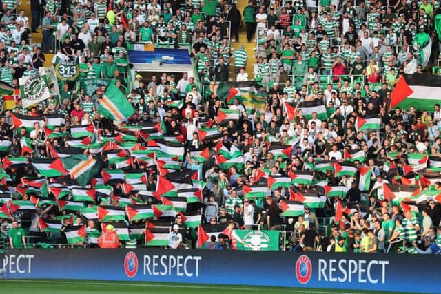 Palestinian flags are waved by Celtic fans during the match. Picture: Getty Images