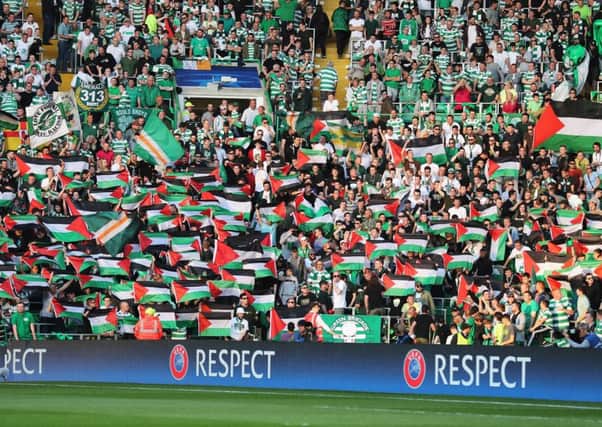 Palestinian flags are waved by Celtic fans during the match. Picture: Getty Images