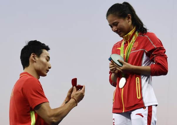 Silver medallist He Zi receives a marriage proposal from fellow diver Qin Kai during her podium ceremony at the Rio Olympics. Picture: AFP/Getty Images