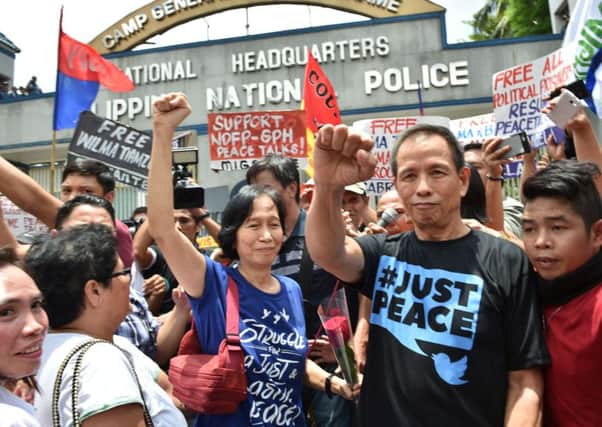 Wilma and Benito Tiamzon are met by supporters outside police headquarters. Picture: AFP/Getty Images