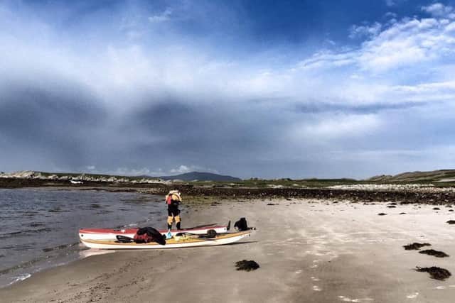 A sea kayaker disembarks at west Loch Tarbet on Jura. Picture: Sea Kayak Scotland