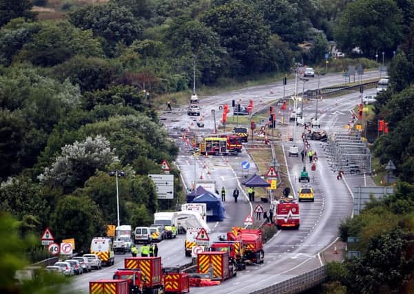 Emergency services work on the A27 at Shoreham in West Sussex following the air disaster. Picture: PA