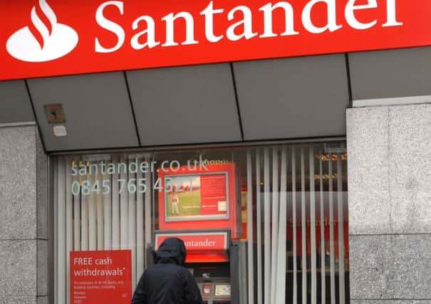 Santander will halve the interest paid to 123 account customers. Photograph: Ian Rutherford