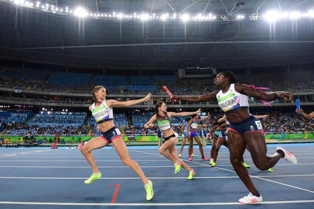 Britain's Kelly Massey (L) grabs the baton from Anyika Onuora en route to a fine bronze. PICTURE: Getty Images