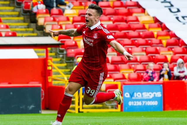Miles Storey wheels away in delight after scoring his first goal for Aberdeen. Pic: Ross Parker/SNS
