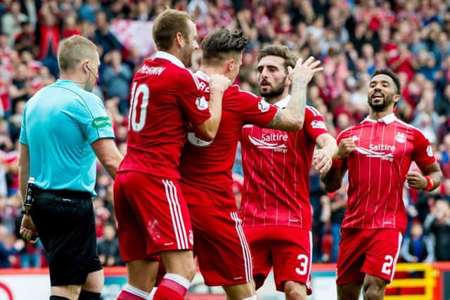 Aberdeen celebrate after Miles Storey put them two ahead with his first goal for the club on Saturday. Picture: SNS