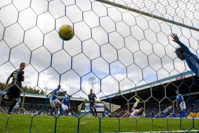 Scott Sinclair, under the floodlight, looks on as his effort sails into the net to give Celtic a 2-0 lead. Picture: SNS