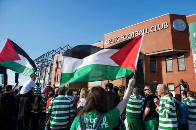 Celtic fans pictured with Palestinian flags outside Parkhead before the match with Hapoel Beer-Sheva. Picture: John Devlin