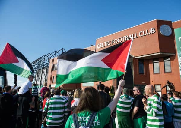 Celtic fans pictured with Palestinian flags outside Parkhead before the match with Hapoel Beer-Sheva. Picture: John Devlin