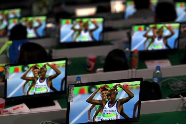 TV screens in the Maracana Stadium show Great Britain's Mo Farah ahead of the Olympic Games closing ceremony. Picture: PA.