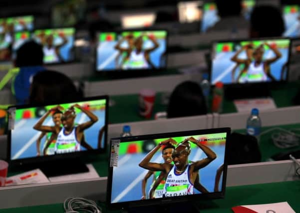 TV screens in the Maracana Stadium show Great Britain's Mo Farah ahead of the Olympic Games closing ceremony. Picture: PA.