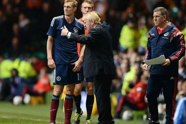 Darren Fletcher is given instructions. Now he is about to retrieve his captain's armband. Picture: SNS.