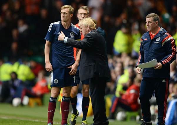 Darren Fletcher is given instructions. Now he is about to retrieve his captain's armband. Picture: SNS.