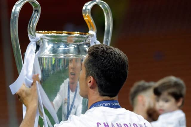 Real Madrid's Cristiano Ronaldo celebrates his side's Champions League triumph in May. The Spanish giants could earn a bigger share of prize money under the proposed Uefa deal. Picture: AP