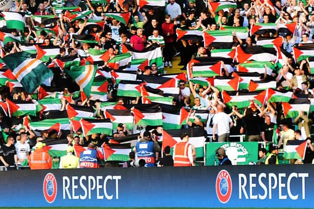 Celtic fans waving Palestinian flags against Hapoel Beer-Sheva. Picture: John Devlin