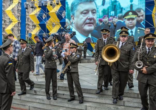 Members of a military orchestra carry their instruments around Independence Square in Kiev. Picture: Getty Images